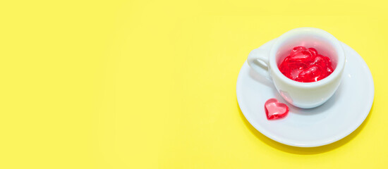 cup with hearts on a red background. the view from the top. red hearts spilled out. isolated on a pink background. copy space. panton