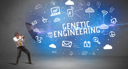 Businessman defending with umbrella from GENETIC ENGINEERING inscription, modern technology concept