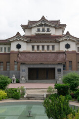 Japanese-built building on the background of a decorative landscape, local History Museum of the city of Yuzhno-Sakhalinsk, Sakhalin Island. summer 2020