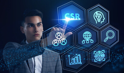The concept of business, technology, the Internet and the network. A young entrepreneur working on a virtual screen of the future and sees the inscription: CSR