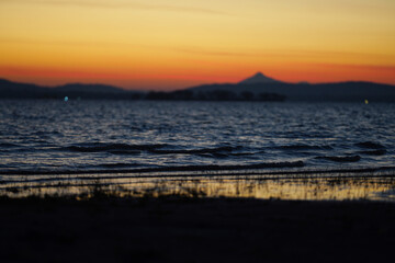 Freshwater sea before sunrise with mountain background