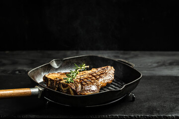 Cooking beef steak on frying grill pan on black. Restaurant menu, dieting, cookbook recipe