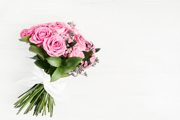 Beautiful bouquet of pink roses flowers with white bow for holiday gift