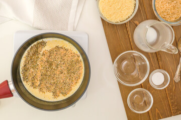 Cooking Alfredo sauce for asparagus casserole. Ingredients close up on kitchen table, view from above