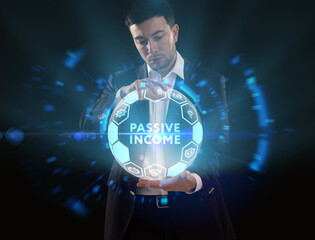Business, Technology, Internet and network concept. Young businessman working on a virtual screen of the future and sees the inscription: Passive income