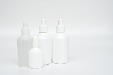 Fototapeta na wymiar White plastic bottles of medicines on neutral background