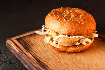 Sandwich. Fast food. Burger with meat and vegetables. Black burger.