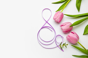 Figure 8 made of violet ribbon and tulip flowers on light background. International Women's Day celebration