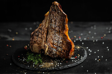 Steak T-bone or aged wagyu porterhouse grilled beef steak with large fillet piece with herbs and...