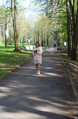 Fototapeta na wymiar young girl in a dress in the park