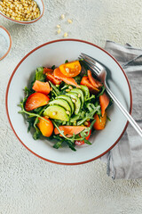Vertical shot of arugula , salmon, avocado, tomato salad. Healthy eating, living. Top view, vertical