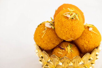Special Banarasi Laddu Indian Mithai Made Of Bengal Gram Flour Deep Fried In Desi Ghee In Golden Bowl. Meetha Laddoo Served On Festivals Like Holi Pooja Diwali Puja Eid Rakshabandhan And Weddings