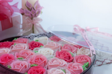 Fototapeta na wymiar Close up of rose shaped dessert in heart shape box for Valentine's day, selective focus, presents for Valentine's day