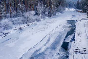 Winter landscape. Aerial view of almost frozen Sema river. Kamlak village, Altai Republic, Russia.