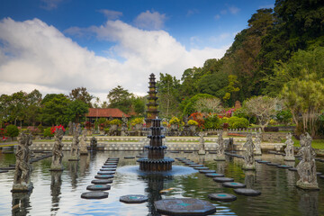 Naklejka premium Water Palace with fountain and pond. Travel and architecture background. Panoramic landscape view. Sunrise time. Indonesia, Bali island