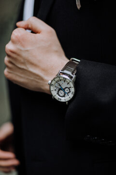 businessman holding watch