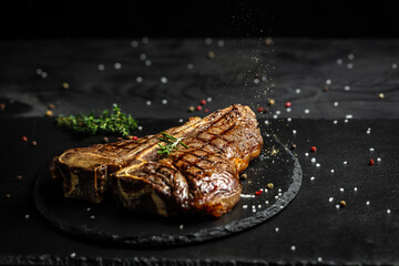 Porterhouse beef steak cooked on a grill. Barbecue aged wagyu porterhouse steak. with spices on a...
