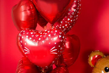 A  set of balloons in the form of hearts for Valentine's Day on a red background.
