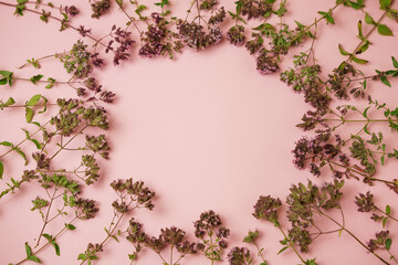 small flowers as a frame on a pink background, a place for an inscription