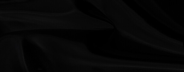 Black gray satin dark fabric texture luxurious shiny that is abstract silk cloth background with patterns soft waves blur beautiful.