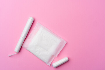 Female hygienic pad and tampons on pink background