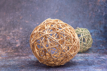 Balls made of rattan, on a dark mottled background