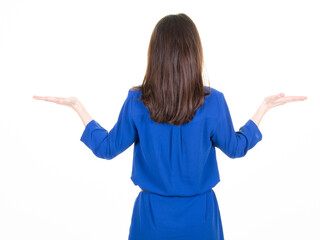 young beautiful woman in blue dress holding imaginary object on the palm back view isolated on white