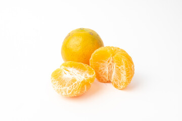 Orange fruit and orange peel, cut in half on white background.