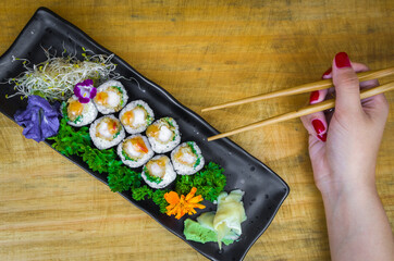 Delicious hossomaki on the decorated plate