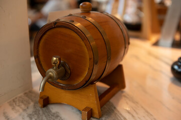 Small oak wine barrel on vintage background, food and drink