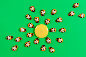 a pattern of orange wooden bees on green background