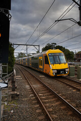 Commuter Train fast moving through a Station in Sydney NSW Australia