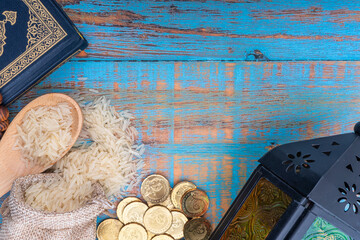 Holy Quran, Coins, Rosary and Rice. Zakat concept. Zakat is a form of alm-giving as a religious obligation