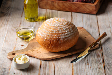 Side view on loaf of olive oil bread on the wooden table