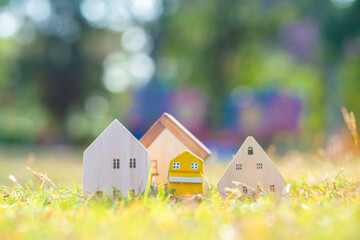 Wooden modern house on green grass with sun light