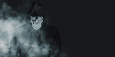 A devil skull in a black robe with a hood and a smoke skull smiling under a black shirt. The spirit in the coat Black background with smog 3d illustration