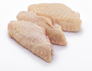 Three clean raw chicken wings, isolated on white background.