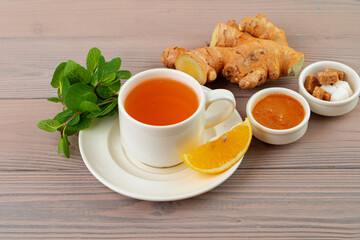 Cup of tea served with lemon and mint