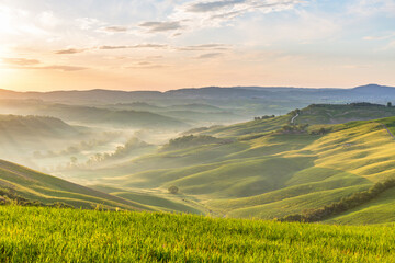 Fototapeta premium Dawn with fog in the valley in Tuscany