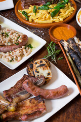 variety of grilled meat and dishes of Spanish cuisine