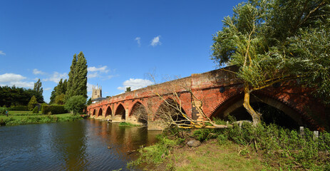 Fototapeta na wymiar Great Barford Packhorse Bridge and Church Bedfordshire England.