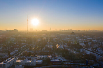 Contre-jour aerial view of the city VDNKh and Ostankino tower at sunny winter day. Moscow, Russia.