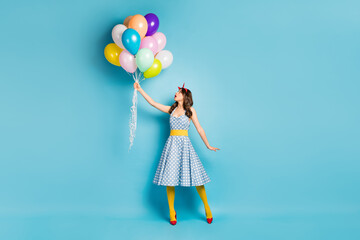 Full length body size view of her she nice-looking attractive lovely pretty amazed wavy-haired girl holding air balls flying up isolated on bright vivid shine vibrant blue color background