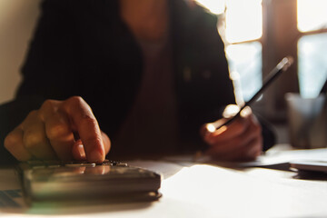 businessman hand using calculator Calculating bonus(Or other compensation) to employees to increase productivity, work from home, quarantine . Selective Focus