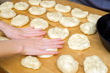 the process of making buns, pies. Turn hands shape the dough. Test preparation