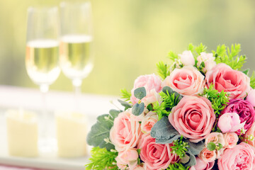 Sweet color rose bouquet with two glasses of wine, love, dating and anniversary concept