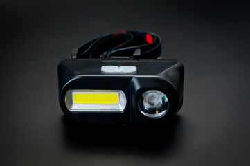 LED headlamp with two light sources for tourism, sports and work. © Pavlo