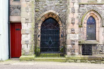 Fototapeta na wymiar Caernarfon harbour Masonic lodge gate with the number 321 and freemasonry symbols in the wrought iron work which relate to their heritage from the middle ages.