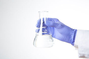 hand with blue glove holding a test tube isolated on white background 