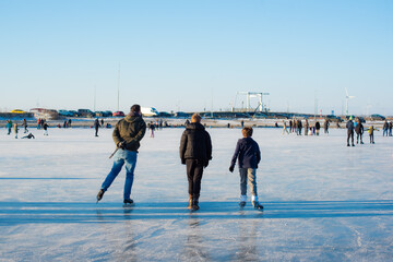 people enjoy ice skating. in zeewolde near Tulpeiland. profitable conditions. frozen lake. on a...